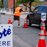 Colorado’s top election official sues Postal Service over flyer that contains incorrect mail-in voting information